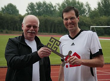 Foto: Dr. Bongartz (rechts) überreicht Sportsenator Mäurer symbolisch einen Schlüssel für das neue Leichtathletik-Stadion Obervieland